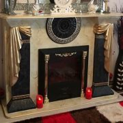 black and gold fireplace with fleur de leys 1