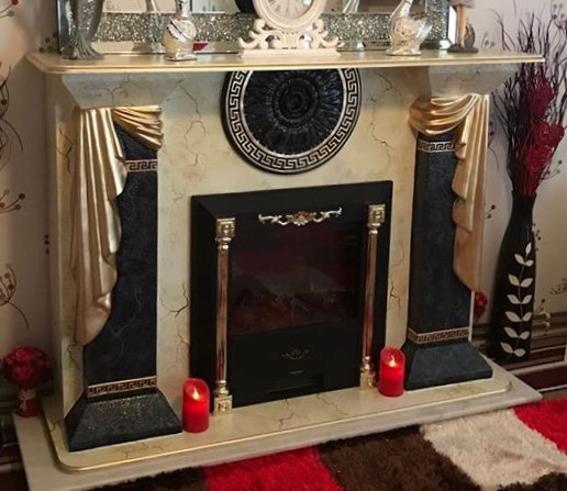 black and gold fireplace with fleur de leys 1